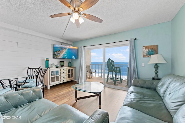 8743 Thomas Dr Unit 809, Panama City Beach, FL 32408 - living area with a textured ceiling, wood finished floors, and ceiling fan