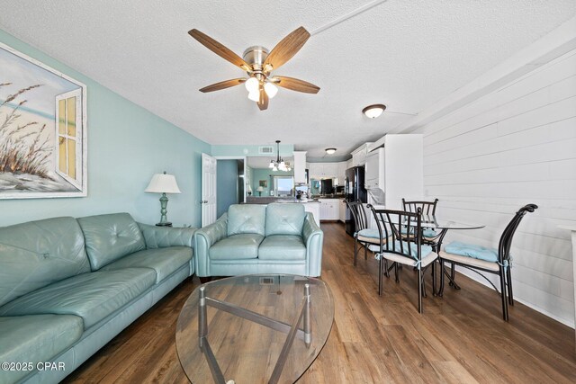 8743 Thomas Dr Unit 809, Panama City Beach, FL 32408 - living area with wood finished floors, a ceiling fan, and a textured ceiling
