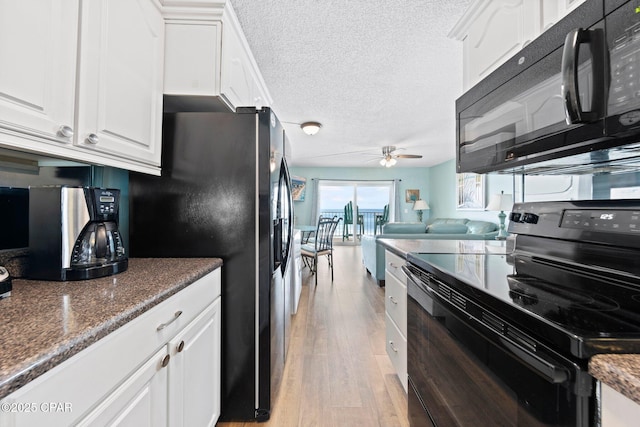 8743 Thomas Dr Unit 809, Panama City Beach, FL 32408 - kitchen featuring black appliances, a ceiling fan, white cabinetry, a textured ceiling, and light wood-style floors