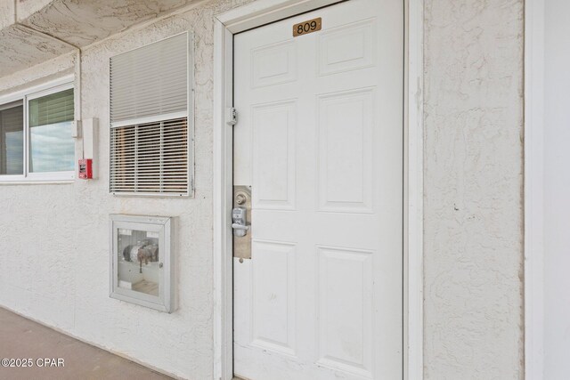 8743 Thomas Dr Unit 809, Panama City Beach, FL 32408 - view of exterior entry with stucco siding