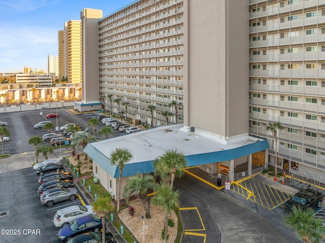 8743 Thomas Dr Unit 809, Panama City Beach, FL 32408 - view of building exterior featuring a view of city and uncovered parking