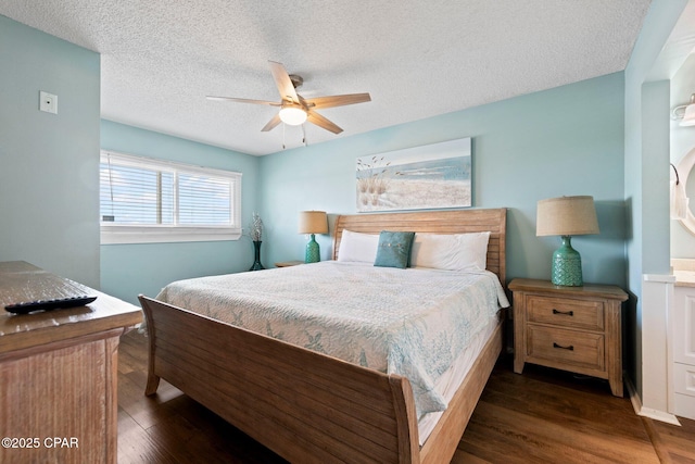 8743 Thomas Dr Unit 809, Panama City Beach, FL 32408 - bedroom with wood finished floors, a textured ceiling, and a ceiling fan