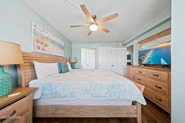 8743 Thomas Dr Unit 809, Panama City Beach, FL 32408 - bedroom with wood finished floors, a textured ceiling, and ceiling fan