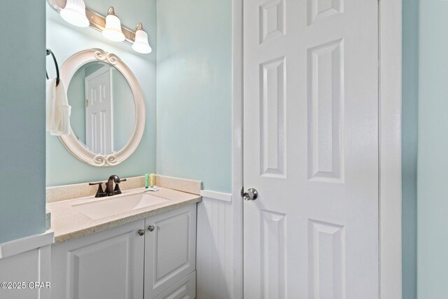 8743 Thomas Dr Unit 809, Panama City Beach, FL 32408 - bathroom featuring a wainscoted wall and vanity