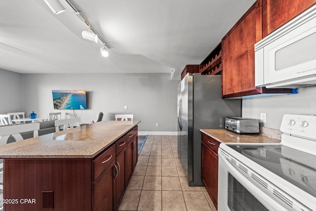 9860 S Thomas Dr Unit 1018, Panama City Beach, FL 32408 - kitchen featuring white appliances, a kitchen island, baseboards, light tile patterned floors, and track lighting