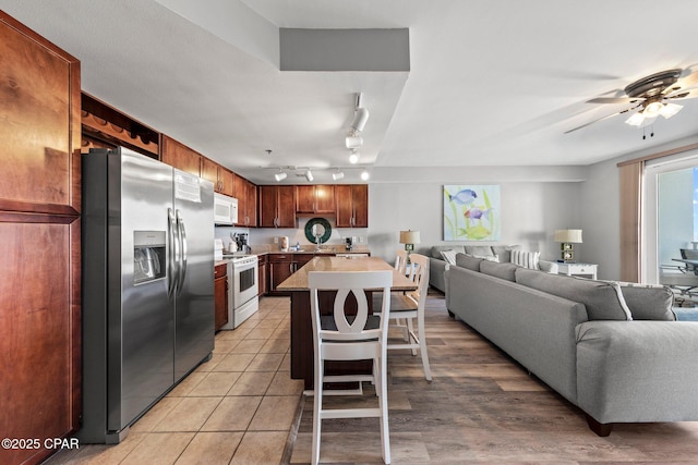 9860 S Thomas Dr Unit 1018, Panama City Beach, FL 32408 - kitchen with white appliances, open floor plan, rail lighting, and light countertops