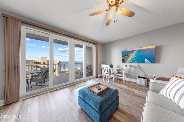 9860 S Thomas Dr Unit 1018, Panama City Beach, FL 32408 - living area featuring wood finished floors, baseboards, and a ceiling fan