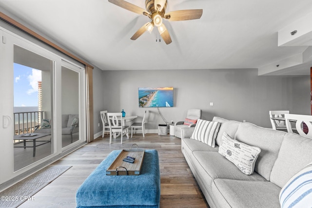 9860 S Thomas Dr Unit 1018, Panama City Beach, FL 32408 - living area featuring wood finished floors, baseboards, and a ceiling fan