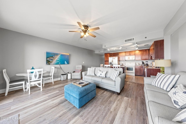 9860 S Thomas Dr Unit 1018, Panama City Beach, FL 32408 - living room with light wood-style floors, ceiling fan, and rail lighting