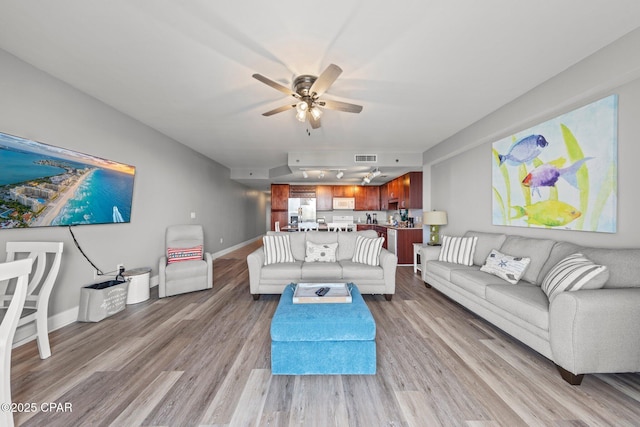 9860 S Thomas Dr Unit 1018, Panama City Beach, FL 32408 - living area with a ceiling fan, wood finished floors, and baseboards