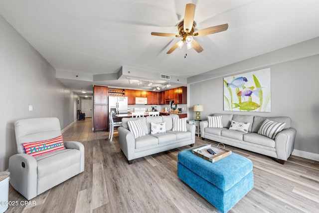 9860 S Thomas Dr Unit 1018, Panama City Beach, FL 32408 - living area with light wood-type flooring, ceiling fan, and baseboards