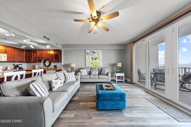 9860 S Thomas Dr Unit 1018, Panama City Beach, FL 32408 - living room with a ceiling fan, light wood finished floors, and rail lighting