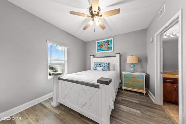 9860 S Thomas Dr Unit 1018, Panama City Beach, FL 32408 - bedroom with baseboards, wood finished floors, connected bathroom, and a ceiling fan