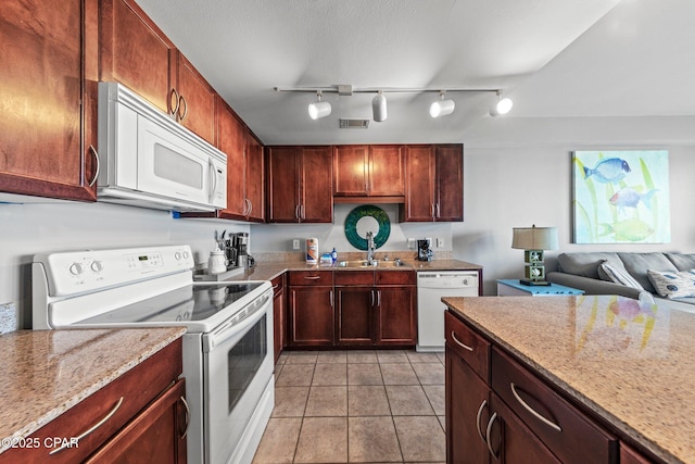 9860 S Thomas Dr Unit 1018, Panama City Beach, FL 32408 - kitchen featuring white appliances, a sink, light stone countertops, light tile patterned floors, and rail lighting