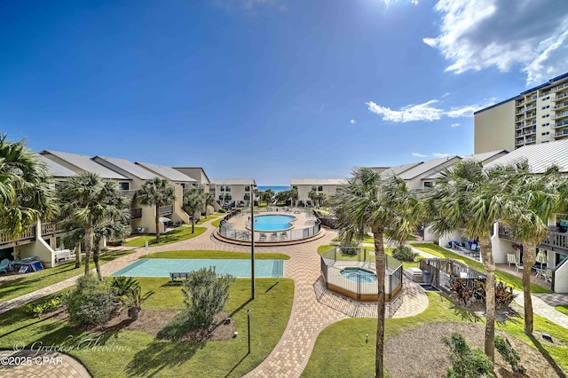 5717 Thomas Dr Unit B137, Panama City Beach, FL 32408 - community pool with a hot tub, a lawn, a residential view, and a patio area