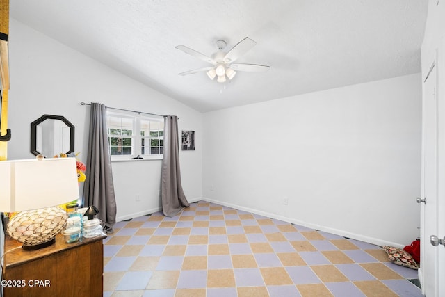 629 Old Forest Way, Panama City, FL 32404 - empty room with a ceiling fan, vaulted ceiling, baseboards, and a textured ceiling
