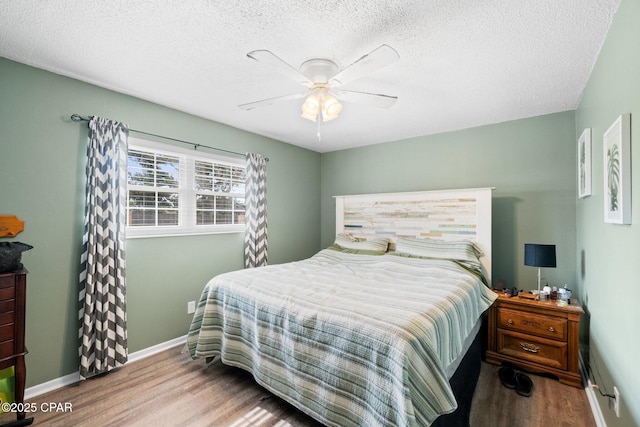 629 Old Forest Way, Panama City, FL 32404 - bedroom with wood finished floors, baseboards, a textured ceiling, and a ceiling fan