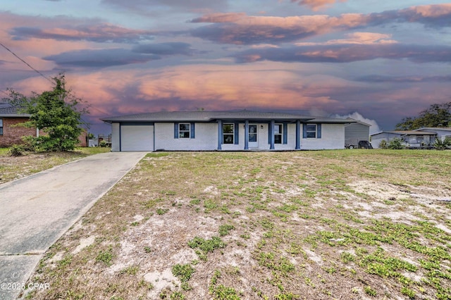 4102 Leslie Ln, Panama City, FL 32404 - view of front of home with a front lawn, brick siding, a garage, a porch, and concrete driveway