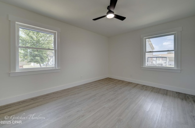 spare room with a ceiling fan, baseboards, and light wood-type flooring