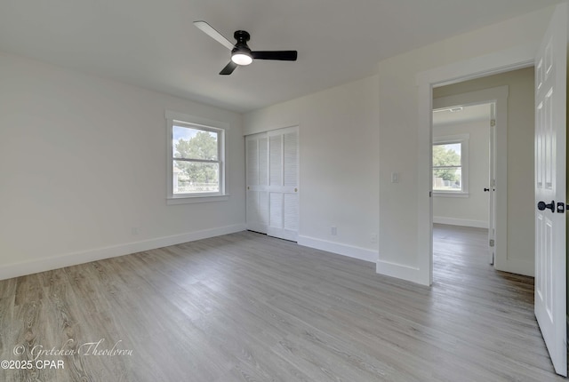 unfurnished bedroom with baseboards, a ceiling fan, a closet, and wood finished floors