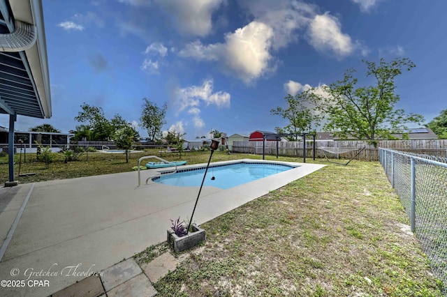 view of pool featuring a lawn, a fenced in pool, and a fenced backyard