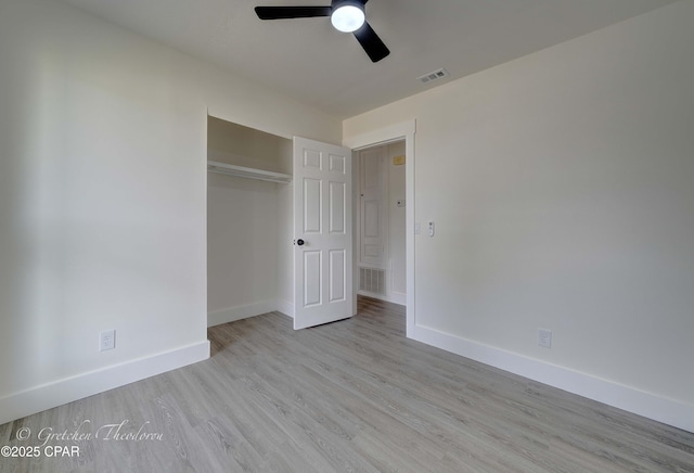 unfurnished bedroom with visible vents, baseboards, and wood finished floors