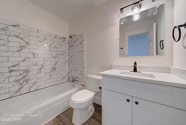 full bathroom featuring vanity, bathtub / shower combination, toilet, and wood finished floors
