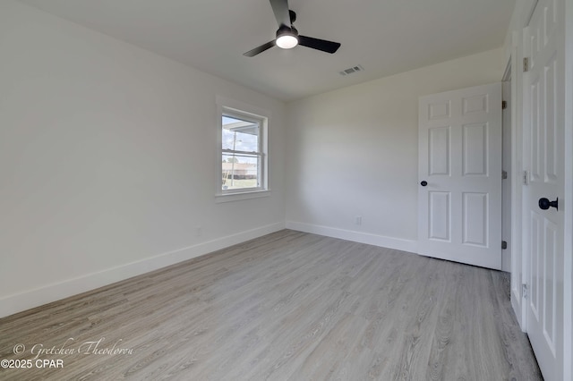 unfurnished bedroom with baseboards, a ceiling fan, wood finished floors, and visible vents