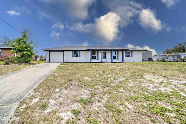 single story home featuring a garage, concrete driveway, a front yard, and brick siding