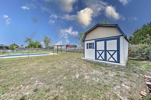 view of shed featuring a fenced in pool and a fenced backyard
