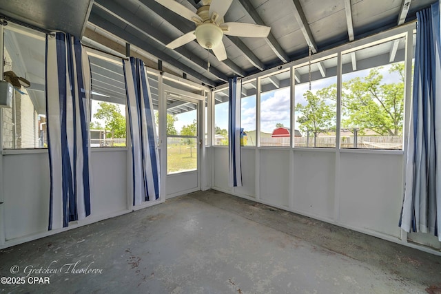 unfurnished sunroom featuring a ceiling fan