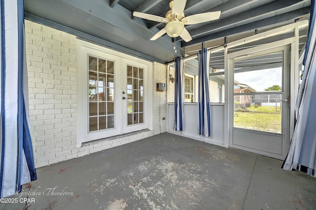 unfurnished sunroom with ceiling fan and french doors
