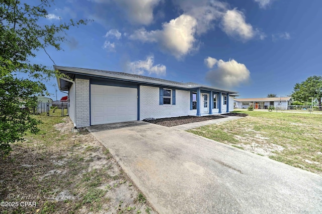 ranch-style house with fence, an attached garage, concrete driveway, and brick siding