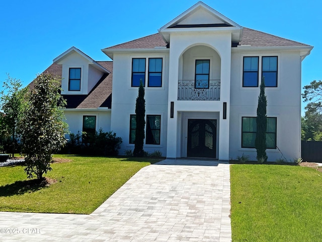 3639 Preserve Blvd, Panama City Beach, FL 32408 - view of front of property with french doors, a shingled roof, a front yard, and stucco siding