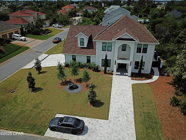 3639 Preserve Blvd, Panama City Beach, FL 32408 - view of front facade with roof with shingles, stucco siding, and a front lawn