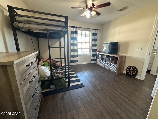 bedroom featuring visible vents, baseboards, and dark wood-type flooring