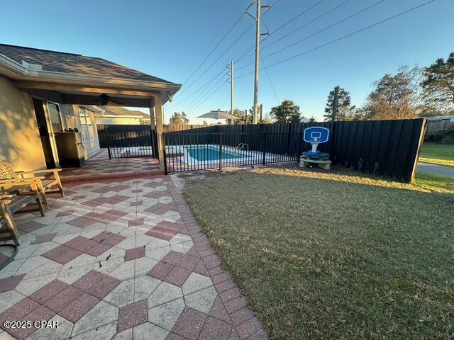 view of yard with a fenced in pool, fence private yard, and a patio area
