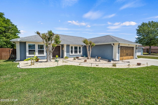 ranch-style home with fence, an attached garage, stucco siding, a front yard, and concrete driveway