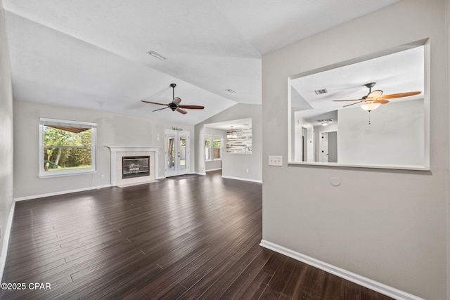 unfurnished living room with a ceiling fan, baseboards, wood finished floors, and lofted ceiling