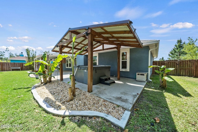 view of patio / terrace featuring a fenced backyard and a hot tub