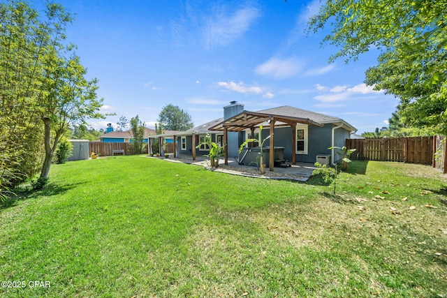 back of property with a jacuzzi, a shed, a fenced backyard, a lawn, and a patio