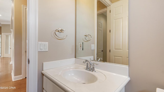 1222 Huntington Ridge Rd, Lynn Haven, FL 32444 - bathroom with crown molding, baseboards, wood finished floors, and vanity