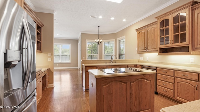 1222 Huntington Ridge Rd, Lynn Haven, FL 32444 - kitchen featuring a chandelier, a center island, stainless steel appliances, wood finished floors, and glass insert cabinets