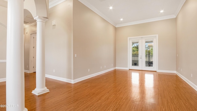 1222 Huntington Ridge Rd, Lynn Haven, FL 32444 - spare room with ornamental molding, baseboards, ornate columns, arched walkways, and light wood finished floors