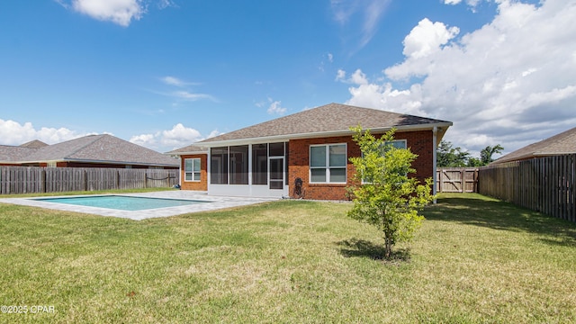 1222 Huntington Ridge Rd, Lynn Haven, FL 32444 - back of property with brick siding, a fenced backyard, a lawn, and a sunroom
