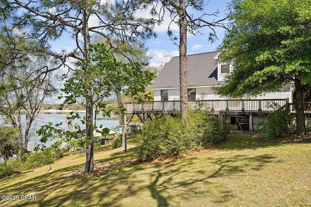 view of yard featuring a deck with water view