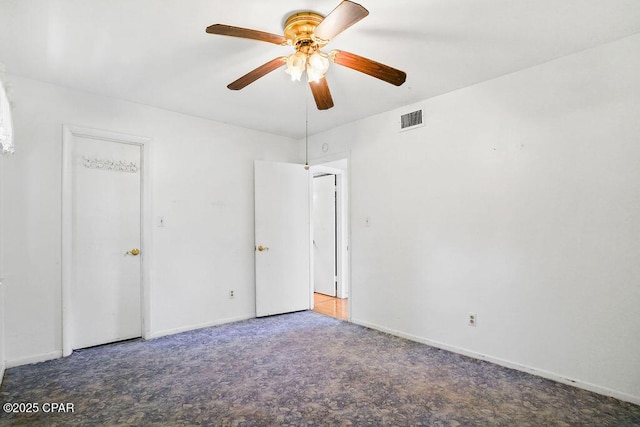 unfurnished bedroom featuring carpet flooring, a ceiling fan, baseboards, and visible vents