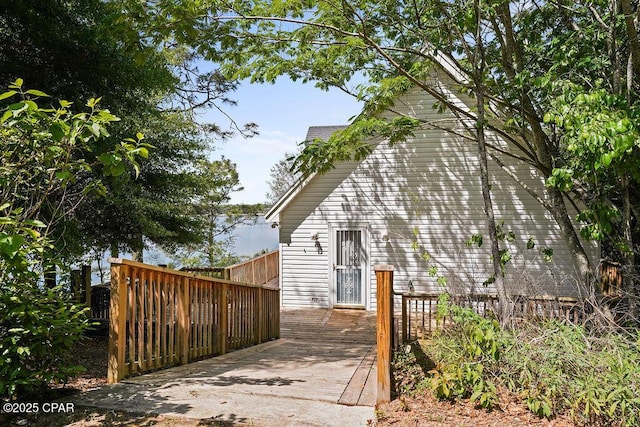 view of property exterior with a wooden deck
