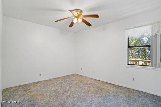 spare room featuring ceiling fan and baseboards