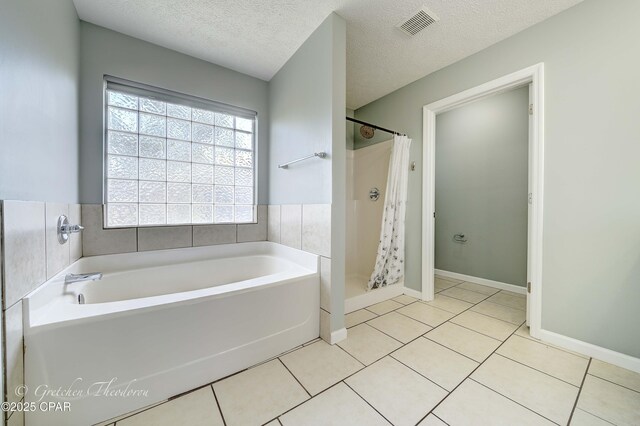 4704 Shannon Ln, Panama City, FL 32404 - bathroom featuring a garden tub, a textured ceiling, visible vents, a shower stall, and tile patterned floors